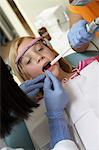 Girl (7-10) having teeth examined at dentists