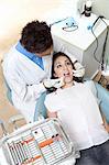 Dentist examining patient in surgery