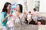 Woman showing gift at baby shower