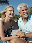 Senior couple holding hands on tropical beach