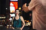 Man  Photographing Elegant Woman in Times Square, at night