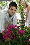 Couple Selecting flowers at plant nursery, portrait