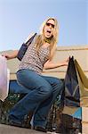 Woman with shopping bags, outdoors, (portrait)