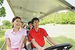 Men And Women Sitting On Golf Cart