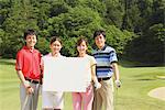 Men And Women Holding White Board On Golf Course