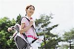 Woman Playing Golf On Golf Course