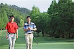 Men Walking On Golf Course