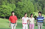 Men And Women Walking On Golf Course