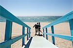 Rear view of couple on beach walkway