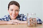 Young woman with jar of coins