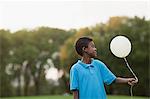 Boy at birthday party holding balloon