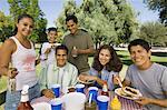 Boy (13-15) with family at picnic.