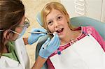 Girl (7-10) having teeth examined at dentists