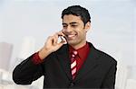 Business man using mobile phone outdoors