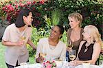 Female friends drinking wine at outdoor table
