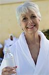 Portrait of senior woman in bathrobe at health spa