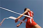 Female track athlete crossing finishing line