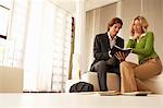 Business couple talking in living room, low angle view