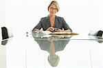 Businesswoman at conference table, portrait