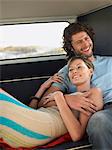 Young couple embracing in back of van