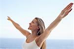 Young woman with arms outstretched on beach