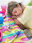 Close-up of boy (7-9) sleeping at table after birthday party