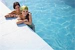 Two teenage girls (16-17) in swimming pool, portrait, elevated view