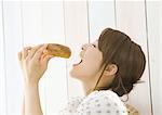 Young woman eating bread
