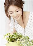 Young woman watering a houseplant