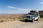 Ethiopia. A 4x4 expedition vehicle stops to take in the view on the road to Lalibela.