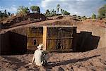 Ethiopia, Lalibela, Bet Giyorgis. A tourist gazes at the rock-hewn church of Bet Giyorgis.