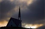 Islande. Un matin de stormy summers, une église dans la campagne près de Reykjavik, la capitale du pays, est décrit par le soleil levant.