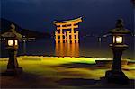 Lanterns infront of red torii gate of Itsukushima jinja shrine