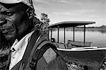 Malawi, Upper Shire Valley, Liwonde National Park. Mvuu Wilderness Camp, a guide leaves his boat to guide a safari walk.