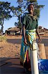 Malawi, Lilongwe, Ntchisi Forest Reserve. With a clean water supply villagers gather to collect water