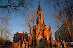 Russia, Siberia, Irkutsk; A neo-Gothic styled church surrounded by trees.