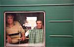 Russia, Siberia; Trans-Siberian; Two elderly men looking across from a moving train, Irkutsk