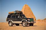 Sudan, Karima. A 4x4 parked by the pyramids at Karima.