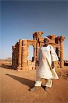 Sudan, Nagaa. The solitary guide at the remote ruins of Nagaa stands in front of the ruins.