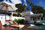 Woman relaxing in sun lounger at Bhu Nga Thani Resort and Spa on Hat Rai Leh East beach, Railay, Krabi Province, Thailan.