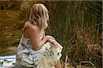 Woman Sitting by Lake, High Park, Toronto, Ontario, Canada