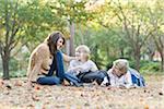 Mother Reading with Sons Outdoors