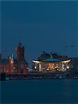 National Assembly for Wales, Cardiff. Exterior at dusk across Cardiff Bay. Architects: Richard Rogers Partnership.