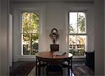 Le Cabinet, Notting Hill, London. Compact room with dining table and two traditional sash windows. Architects: Openstudio