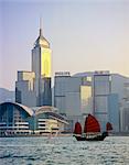 Hong Kong, Chinese junk sailing by Hong Kong Island skyline with Wanchai Tower.