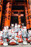 Kitsune or messenger foxes that are a symbol of wealth in Fushimi Inari Shrine, Kyoto, Japan