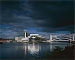 Lowry Arts Centre, Salford Quays, Manchester. Overall exterior with dramatic sky. Architects: Michael Wilford and Partners. Engineers: Engineers: Buro Happold