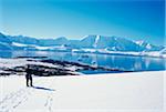 Tourist in snow overlooking landscape of Wiencke Island