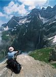 Walker resting and admiring the view across the Cirque de Gavarnie to the highest waterfall in Europe