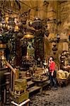 Woman shopping at stalls in covered gateway in Khan El Khalili